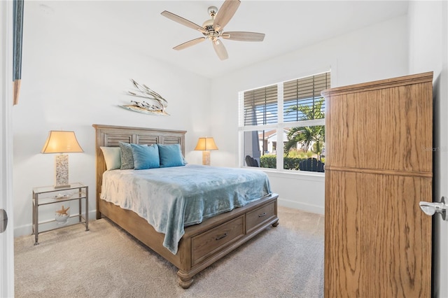 bedroom with light carpet and ceiling fan