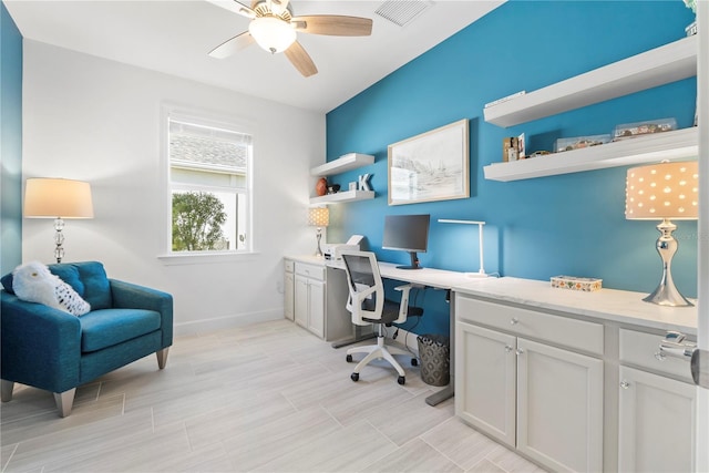 office area featuring ceiling fan, built in desk, and light hardwood / wood-style floors