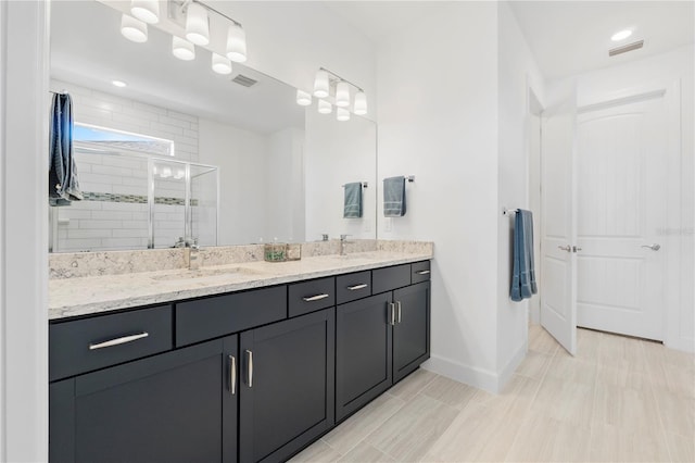 bathroom with vanity and walk in shower