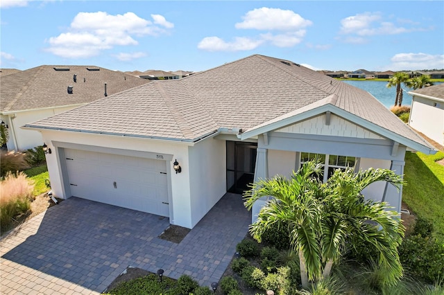 view of front facade with a water view and a garage