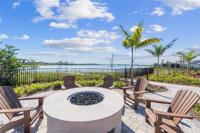 view of patio / terrace with a water view and a fire pit