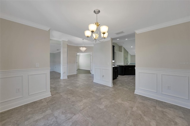 unfurnished dining area featuring ornamental molding and a notable chandelier