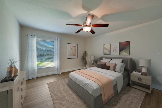 bedroom with ceiling fan and light wood-type flooring