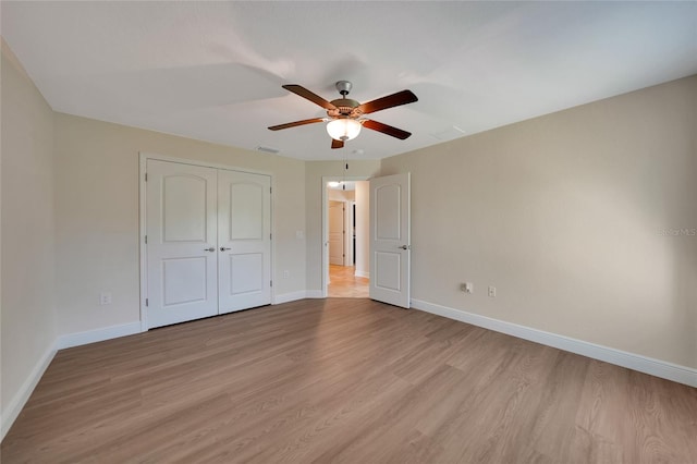 unfurnished bedroom featuring a closet, ceiling fan, and light hardwood / wood-style flooring