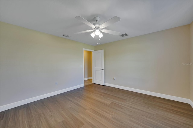 spare room with light hardwood / wood-style flooring and ceiling fan