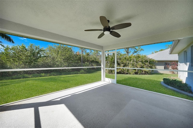 unfurnished sunroom featuring ceiling fan