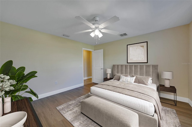 bedroom with ceiling fan and dark hardwood / wood-style floors