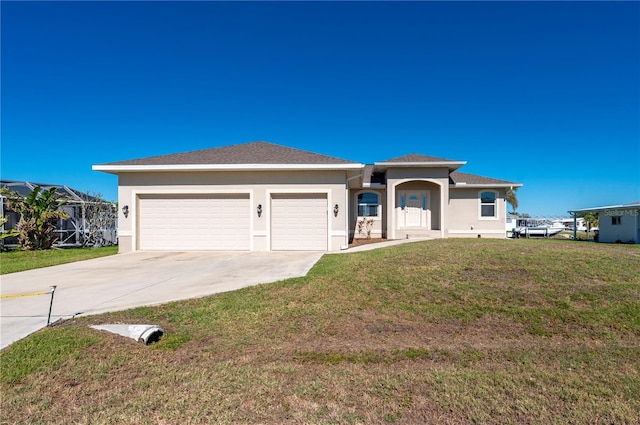 view of front of home with a garage and a front lawn