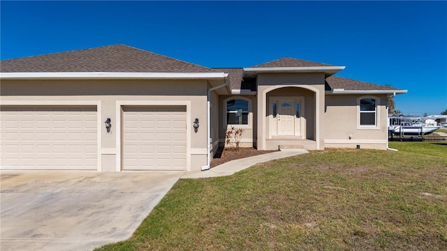 view of front of home with a front lawn and a garage