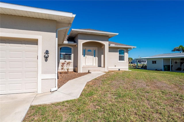 view of front of house featuring a garage and a front lawn