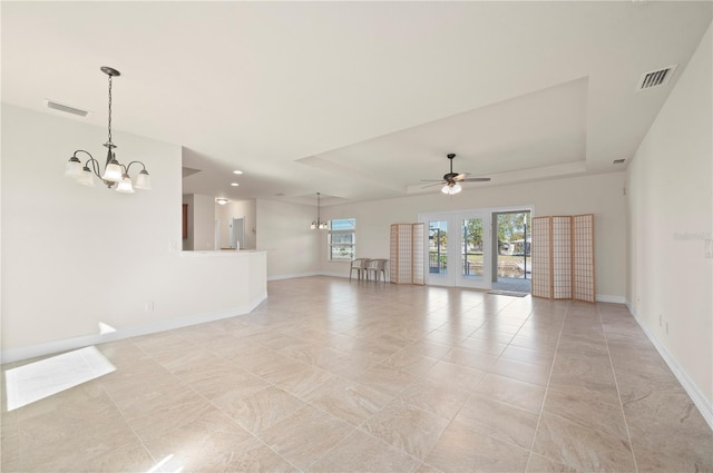 empty room featuring ceiling fan with notable chandelier