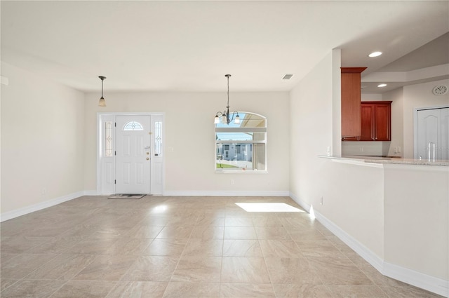 entryway featuring an inviting chandelier and sink