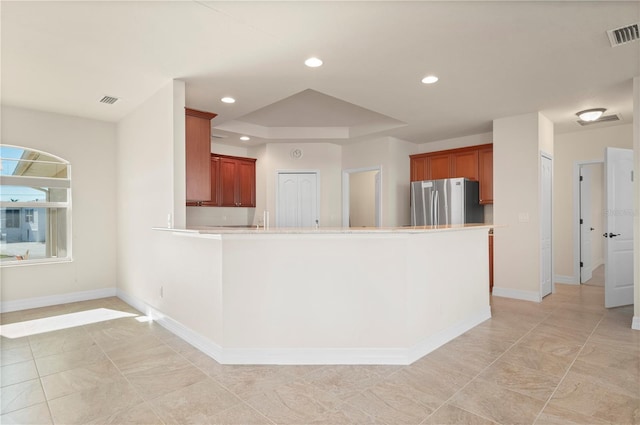 kitchen with stainless steel refrigerator and kitchen peninsula