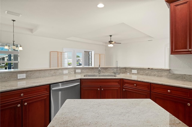 kitchen featuring light stone countertops, ceiling fan with notable chandelier, sink, pendant lighting, and dishwasher