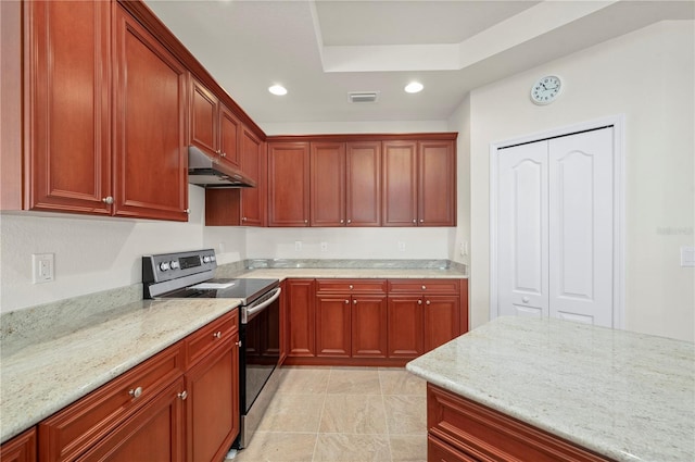 kitchen featuring a tray ceiling, electric stove, and light stone countertops