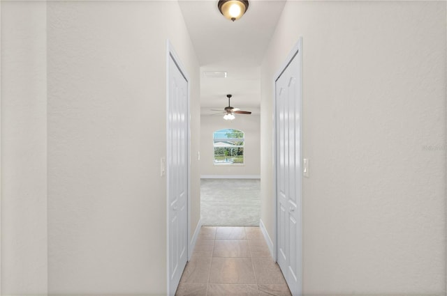 corridor featuring light tile patterned floors