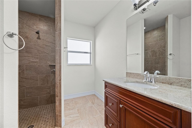 bathroom featuring vanity and tiled shower