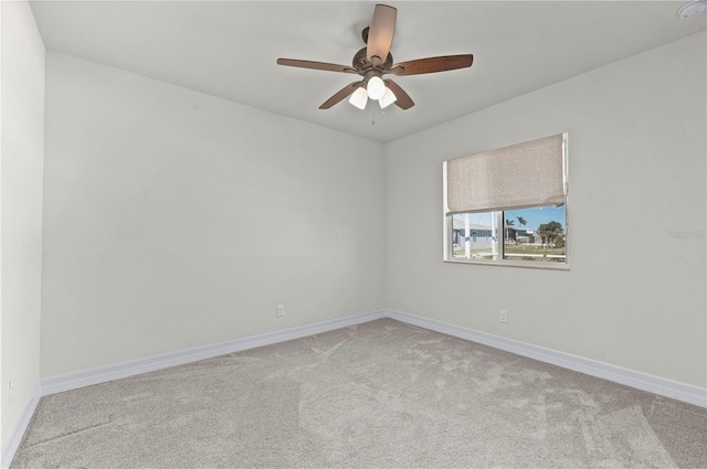 empty room featuring light carpet and ceiling fan