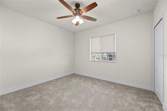 unfurnished bedroom with ceiling fan, light colored carpet, and a closet