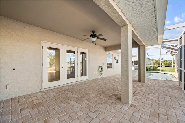 view of patio / terrace with ceiling fan, glass enclosure, and french doors