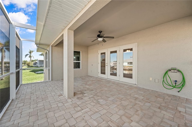 view of patio / terrace with ceiling fan, glass enclosure, and french doors