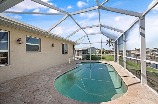 view of swimming pool with a patio and a lanai