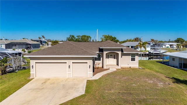 single story home with a garage, a water view, and a front lawn