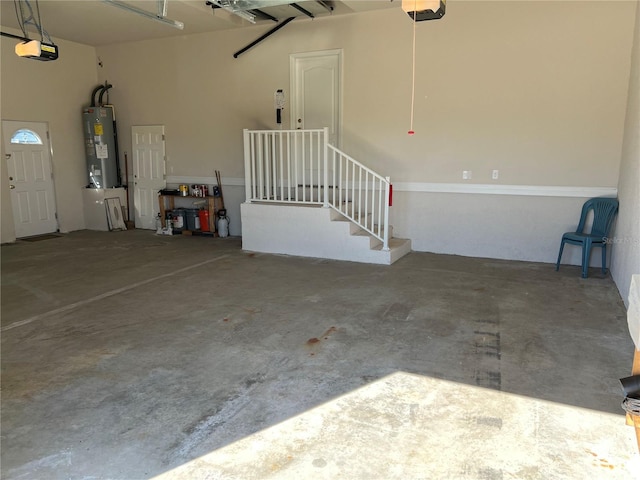 garage featuring electric water heater and a garage door opener