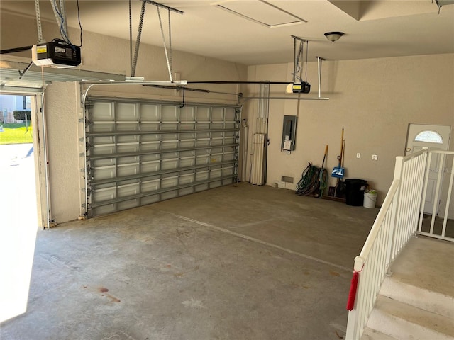 garage featuring electric panel and a garage door opener