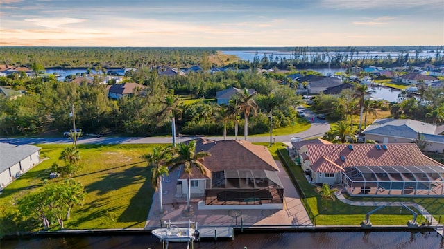 aerial view at dusk with a water view