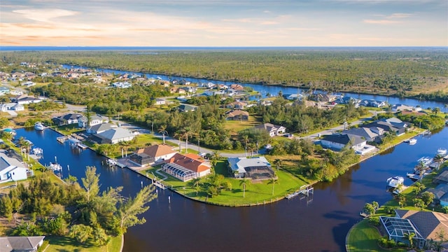 aerial view at dusk with a water view