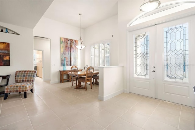 entrance foyer with light tile patterned floors and french doors