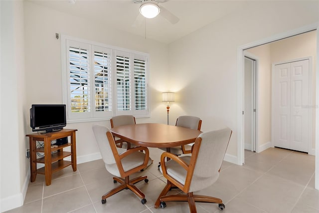 tiled dining room featuring ceiling fan