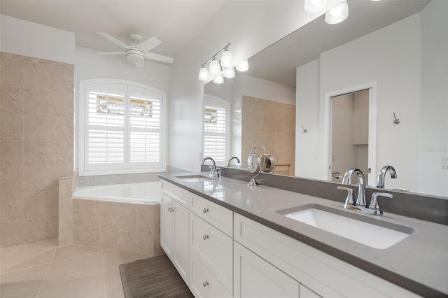 bathroom featuring tile patterned flooring, vanity, a relaxing tiled tub, and ceiling fan