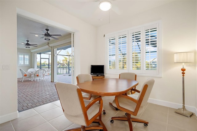 dining space featuring ceiling fan and light tile patterned floors