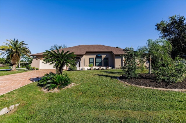 ranch-style house featuring a front yard and a garage