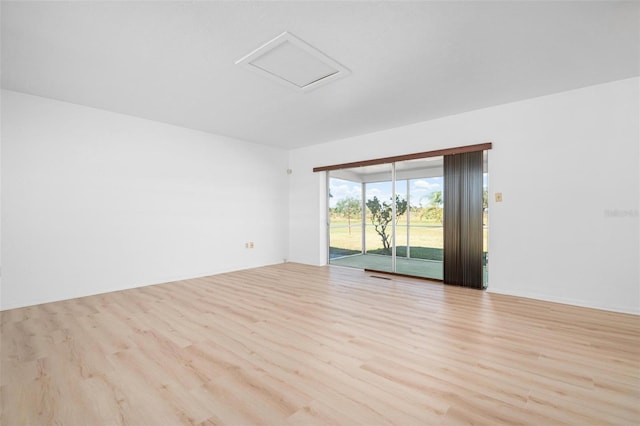 unfurnished room with light wood-type flooring