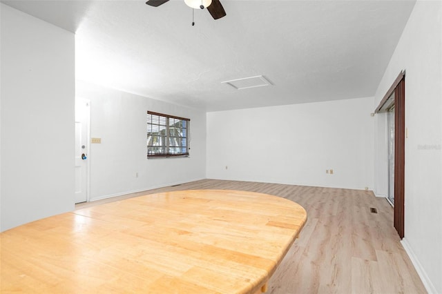 interior space with light wood-type flooring and ceiling fan