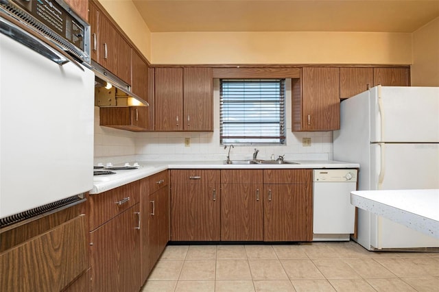 kitchen with light tile patterned floors, white appliances, tasteful backsplash, and sink