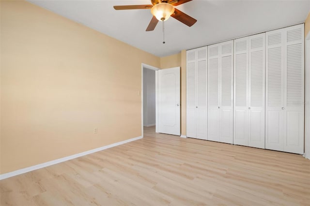 unfurnished bedroom featuring a closet, light hardwood / wood-style floors, and ceiling fan