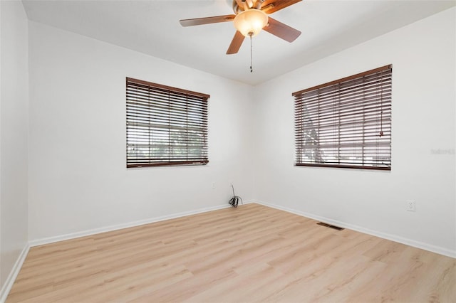 empty room with ceiling fan and light wood-type flooring