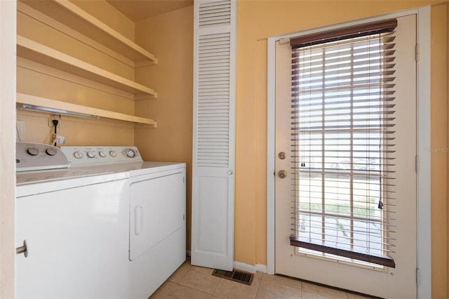 washroom with independent washer and dryer, a wealth of natural light, and light tile patterned flooring