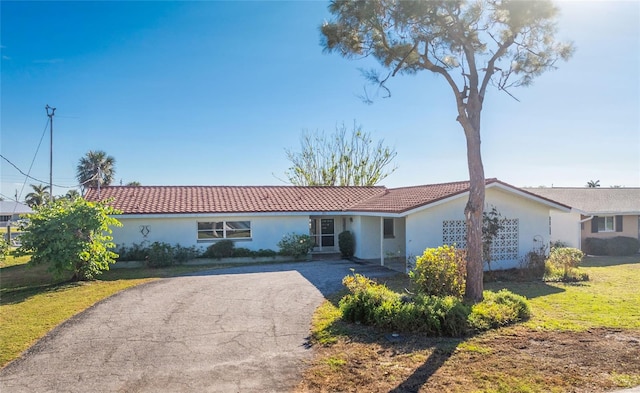 ranch-style house with a front lawn