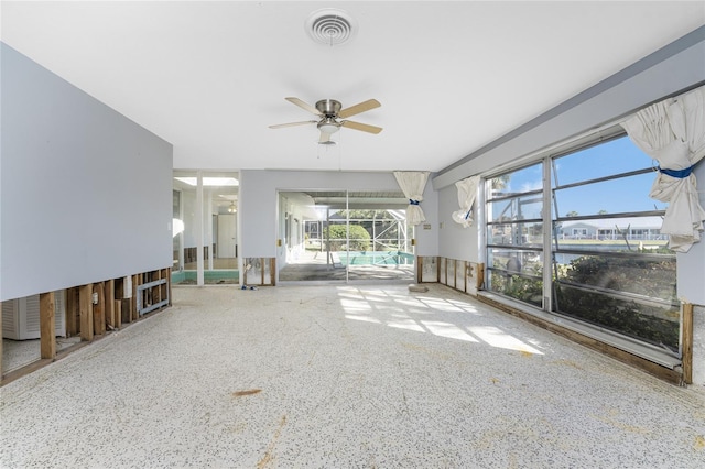 unfurnished living room featuring ceiling fan