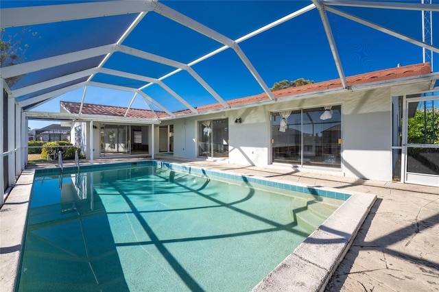 view of pool with a lanai and a patio