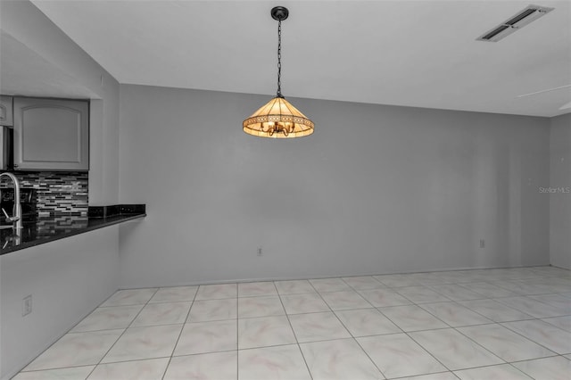 unfurnished dining area featuring light tile patterned flooring