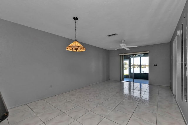 tiled spare room featuring ceiling fan