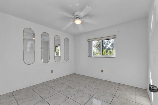 unfurnished room with light tile patterned floors and ceiling fan