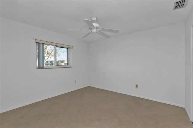 unfurnished room with ceiling fan and light tile patterned flooring