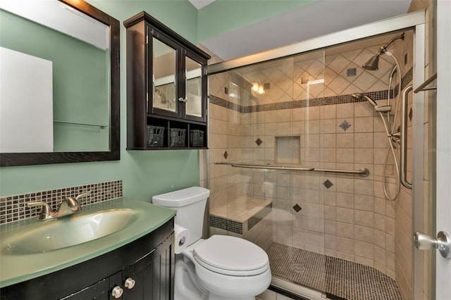 bathroom with backsplash, vanity, toilet, and walk in shower